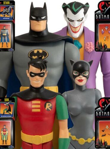 "Set of four Mezco Toyz Batman action figures including Batman, Robin, The Joker, and Catwoman with interchangeable heads and accessories."